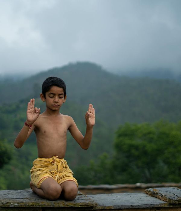 Woman in a calm yoga pose against a serene silvery ice background.